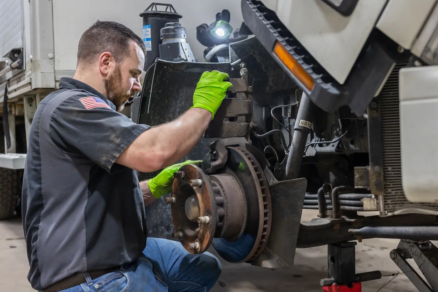 Mechanic repairing truck brakes