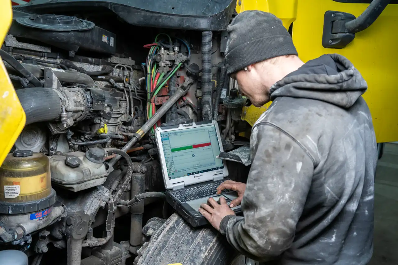 Technician performing diesel computer diagnostics